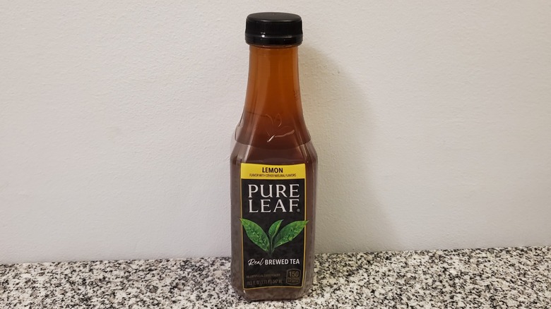 A bottle of Pure Leaf Lemon Black Tea on black and grey granite counter