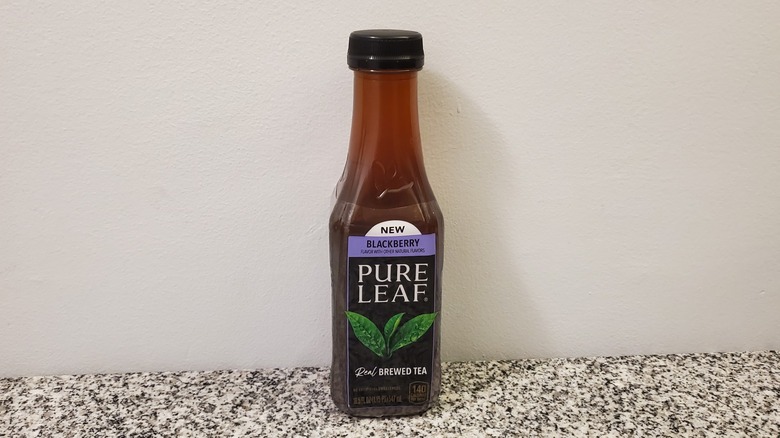 A bottle of Pure Leaf Blackberry Black Tea on black and grey granite counter